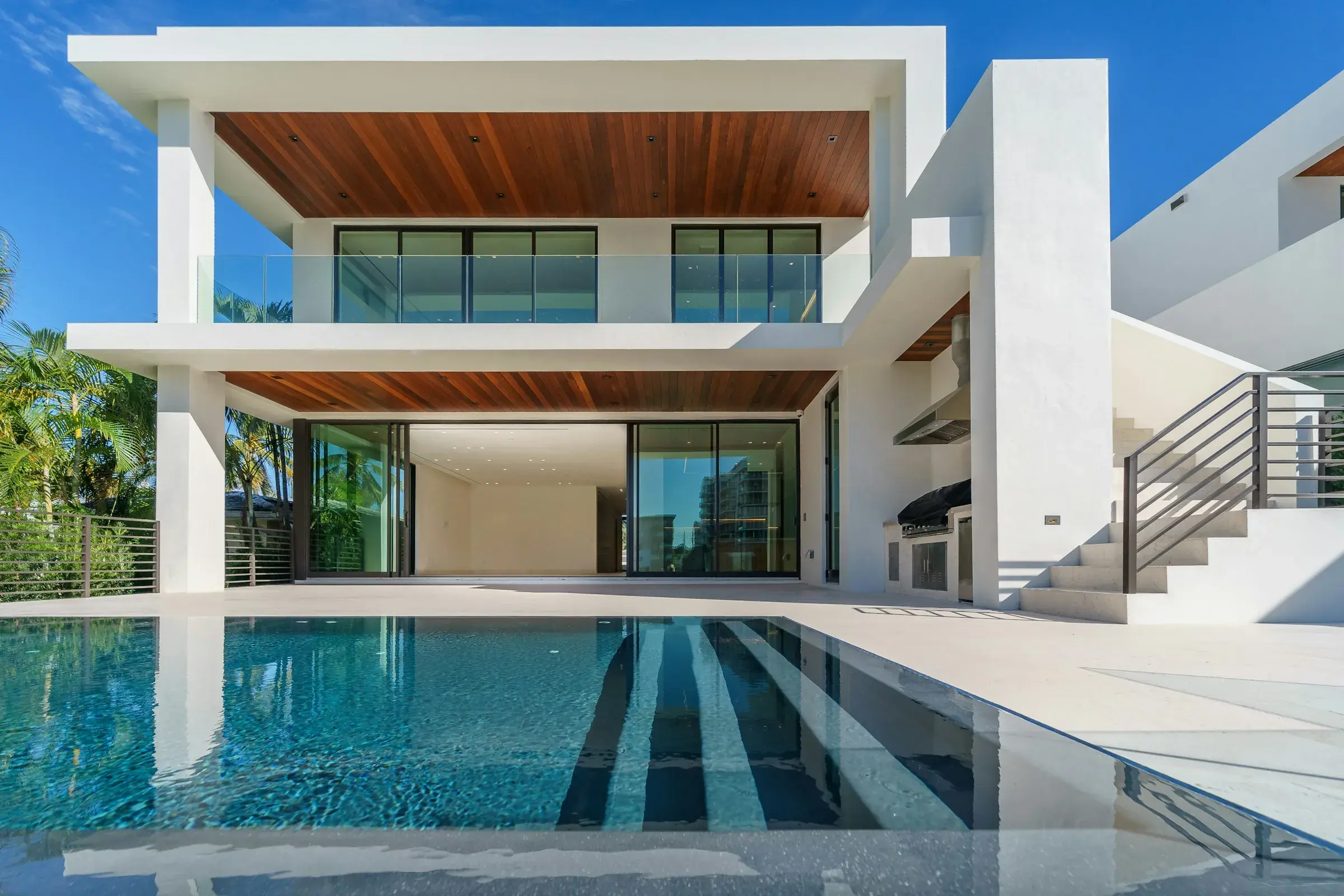Modern two storey house with a long swimming pool