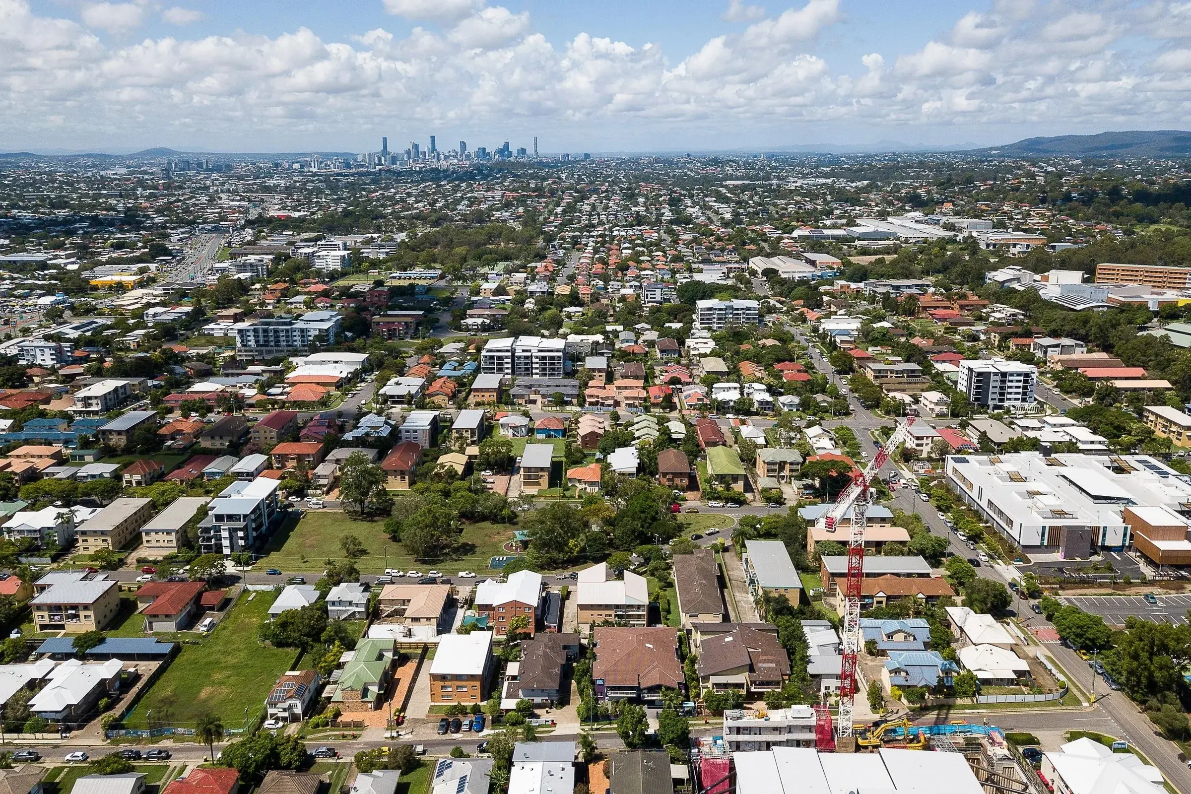 Drone view over the suburbs towards the Brisbane skyline
