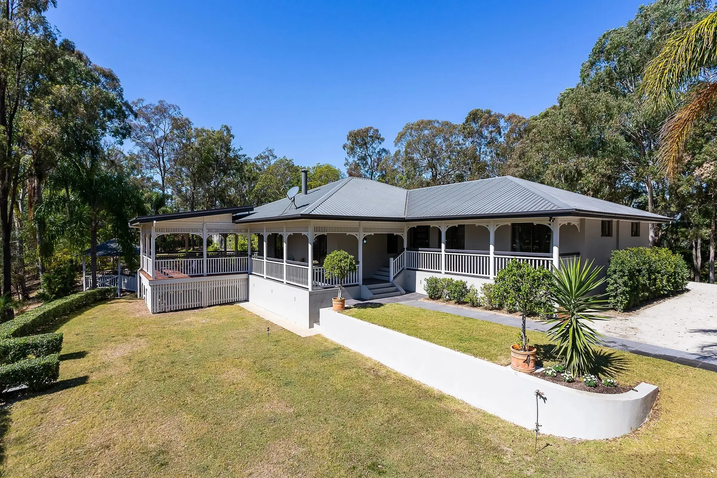 Queenslander with a wraparound verandah on a hill