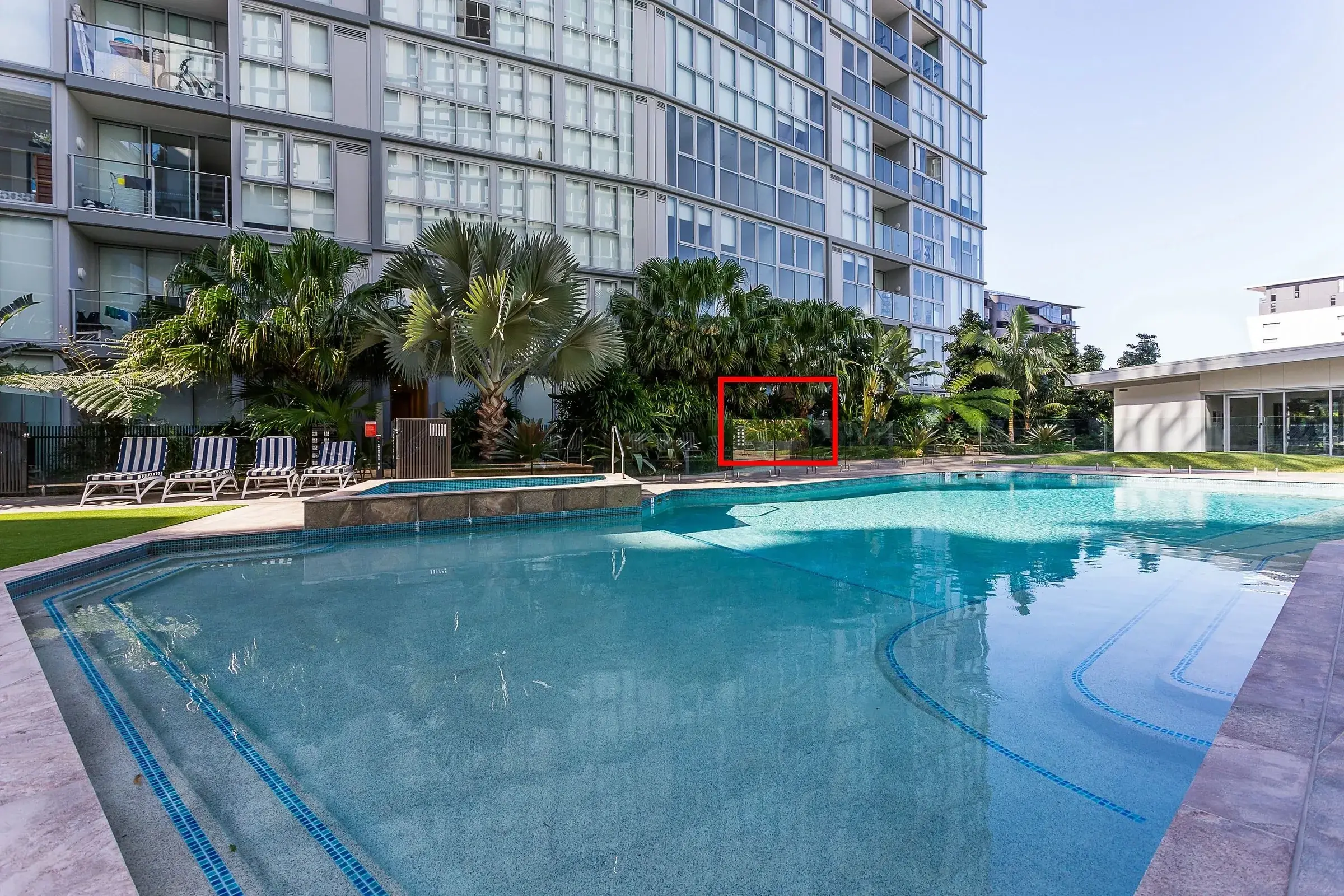 Resort style pool beside an apartment tower