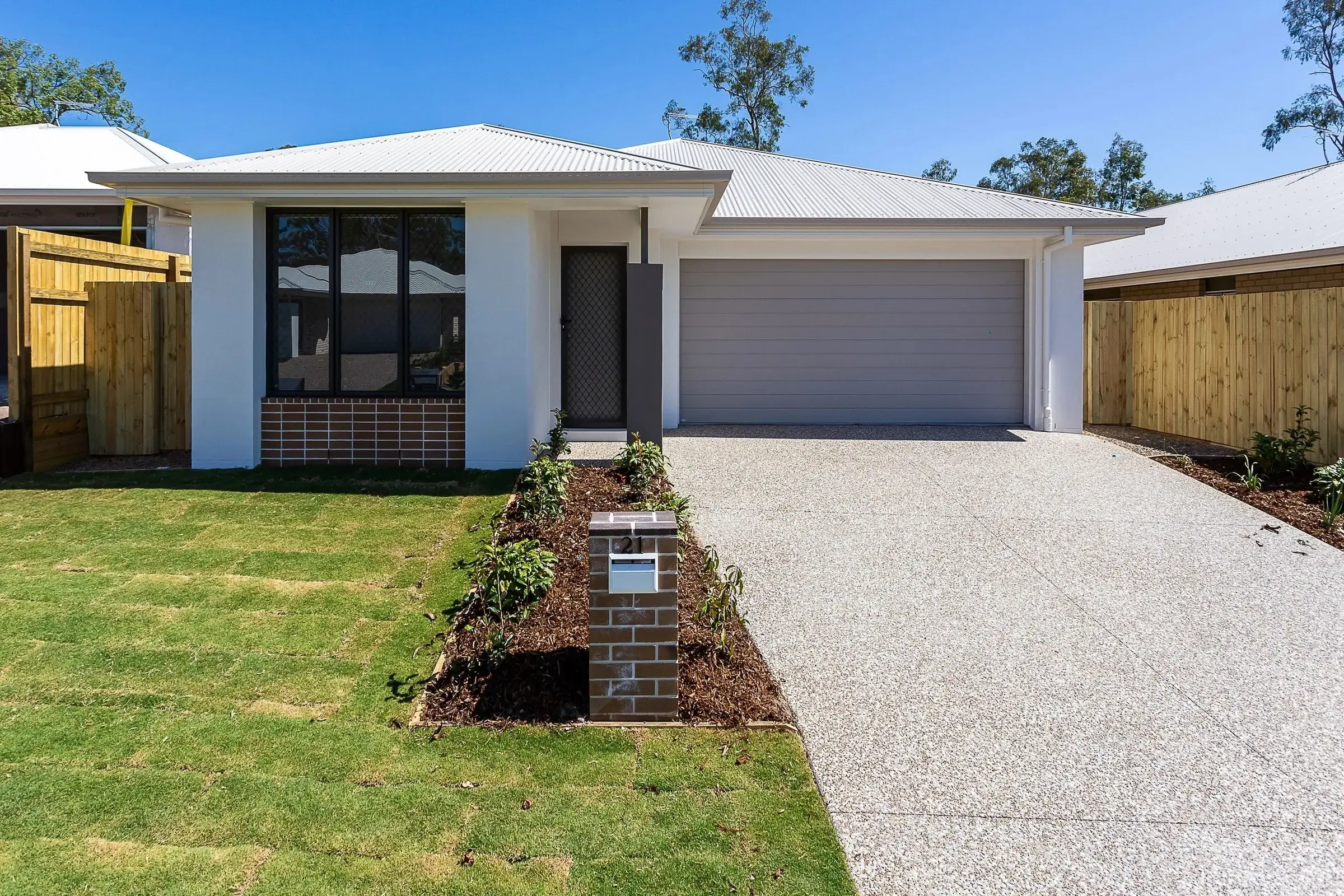 New house with a double garage and concrete driveway